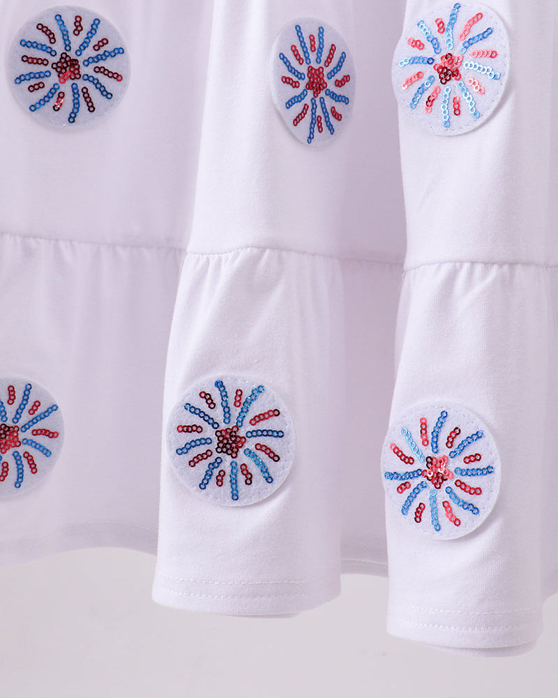 White fabric with decorative blue and red floral patterns on a white background