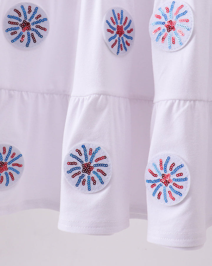 White fabric with decorative blue and red floral patterns on a white background