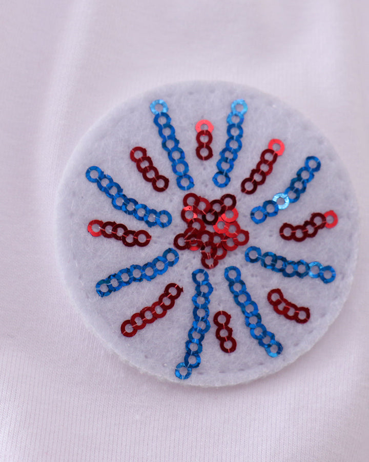 Circular patch with red, blue sequins on a white background