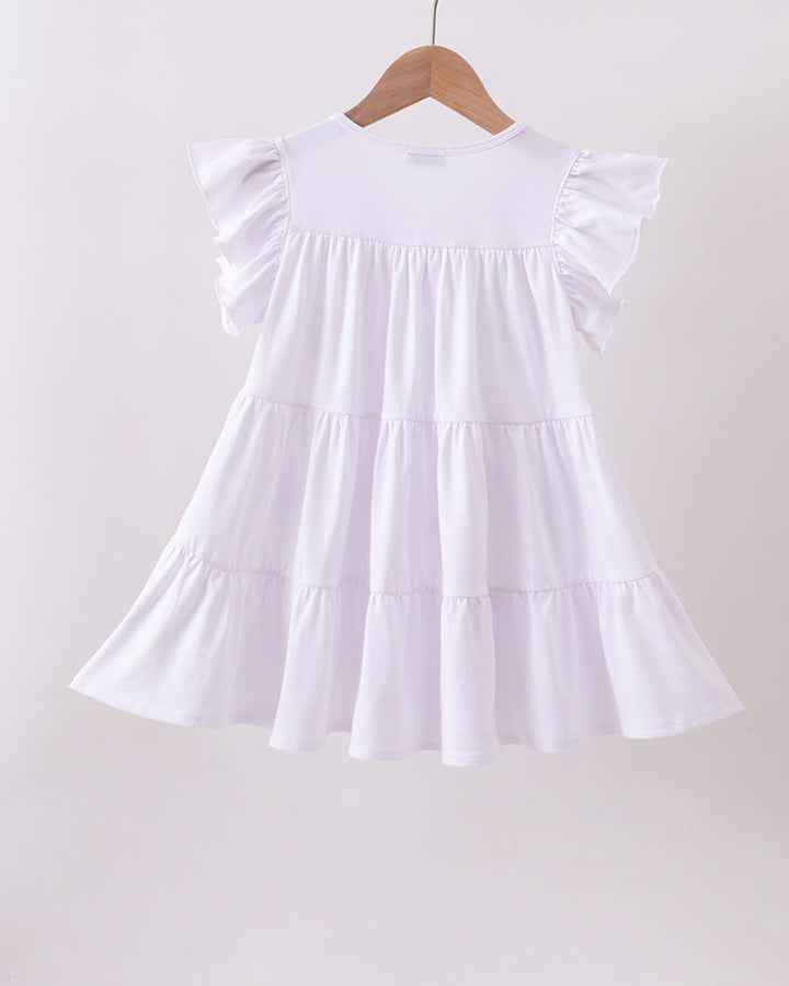 White dress with ruffled sleeves on a wooden hanger against a light background