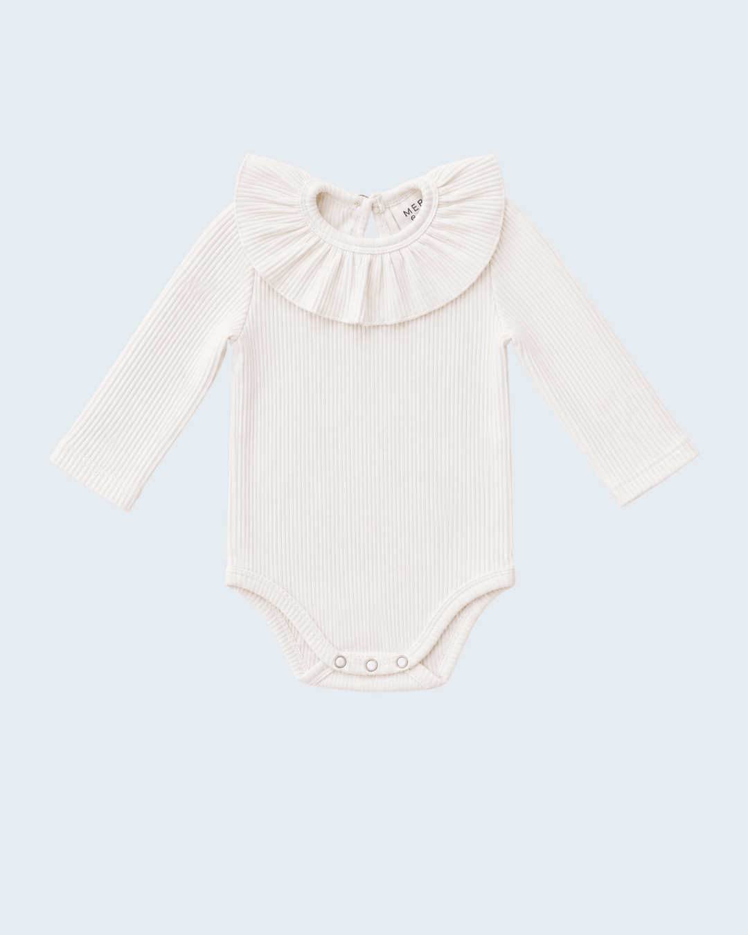 An off-white ribbed long-sleeve baby bodysuit with a large ruffled collar, displayed flat against a light blue-gray background.