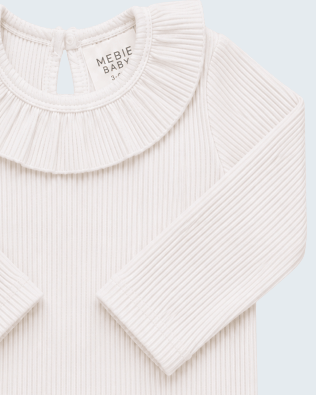 White ribbed long-sleeve top with pleated ruffle collar, MEBIE BABY neck label