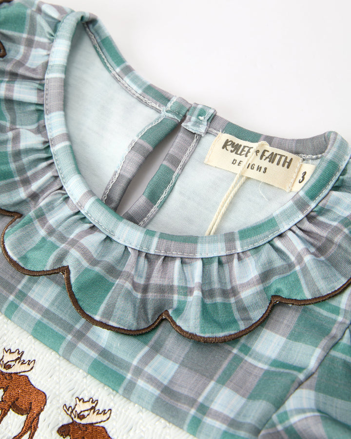 Close-up plaid girls dress neckline with teal ruffle trim and brown scalloped edge