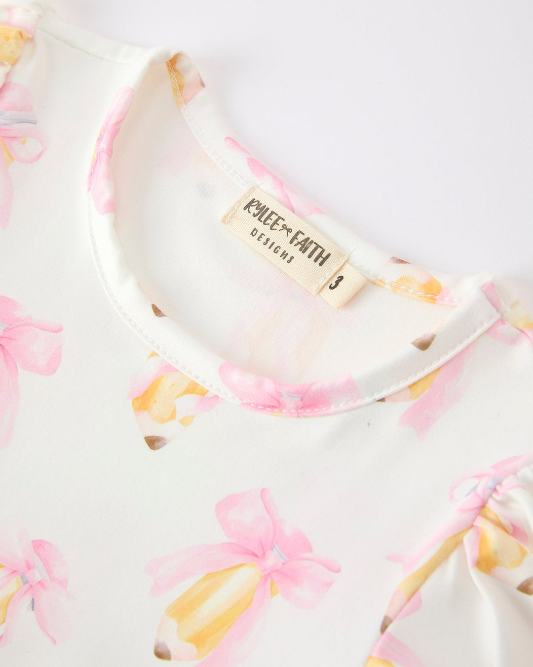 Close-up of a garment with a brand label on a white background