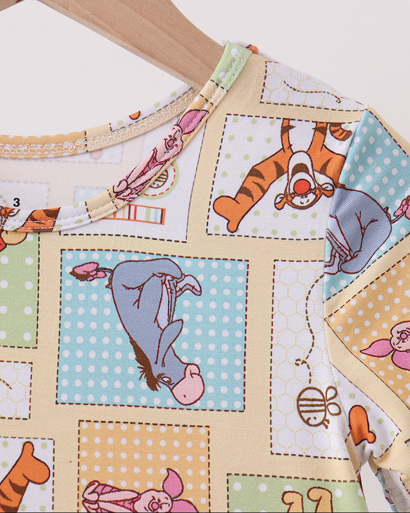 Bamboo dress close-up with Winnie the Pooh patchwork print and stitched neckline trim