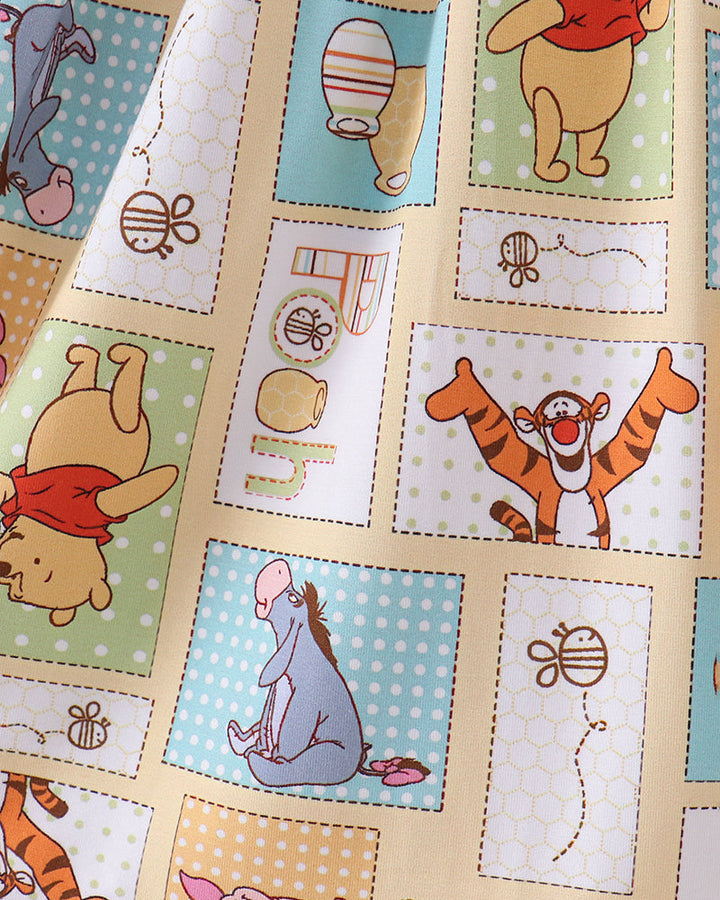 Bamboo dress fabric close-up with Winnie the Pooh animal scenes in patchwork blocks