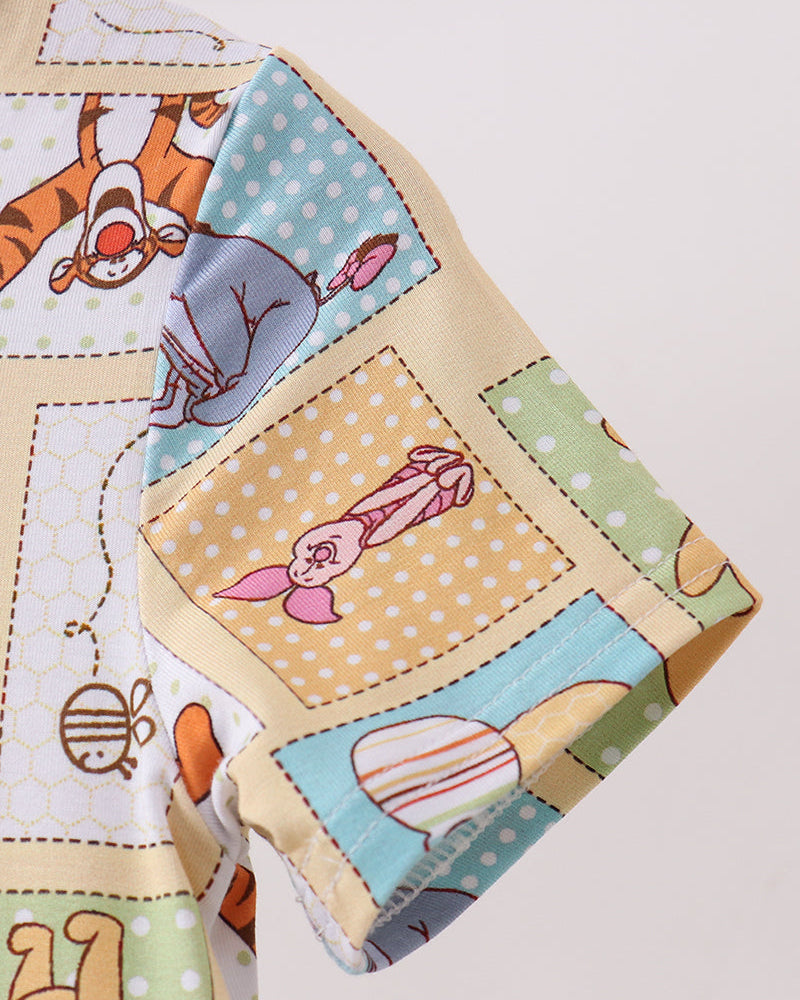 Bamboo dress sleeve close-up with Winnie the Pooh patchwork print and contrast trim