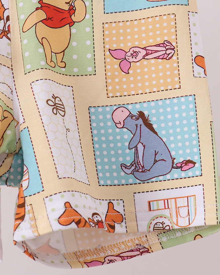 Bamboo pajama top and shorts with colorful Pooh character patch pattern