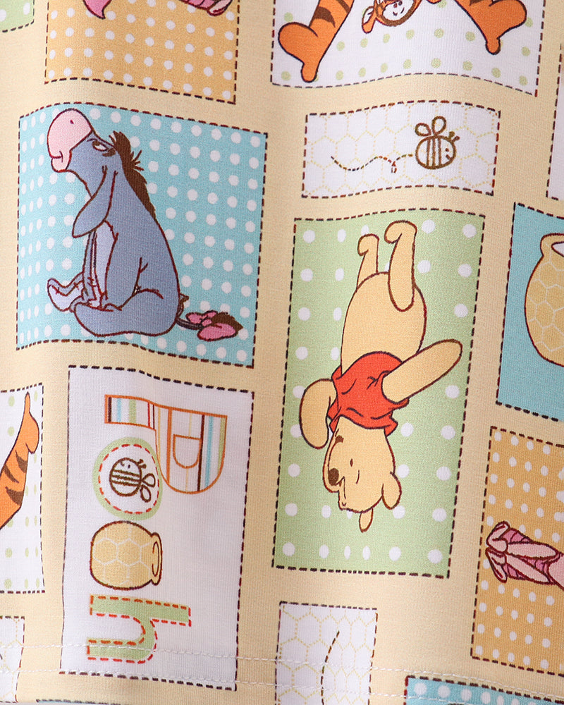 Bamboo pajama fabric close-up with colorful Pooh and friends character squares