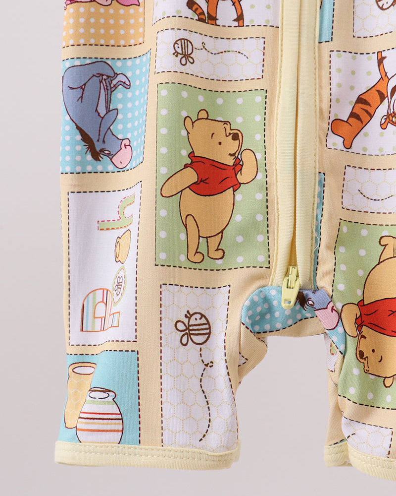 Baby romper leg detail in yellow with cartoon animal and drum patchwork print