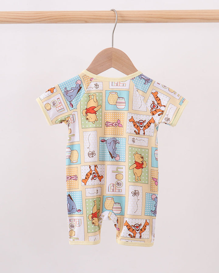 Yellow bamboo baby romper with colorful cartoon patchwork print, short sleeves, full body