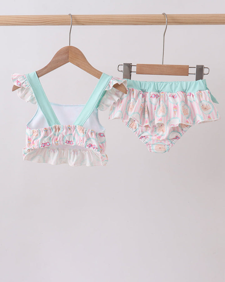 Swimsuit set on hangers against a white background