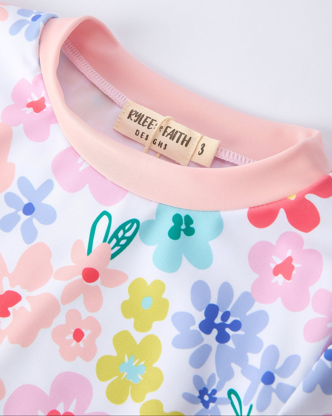 Floral-patterned fabric with a pink elastic band and visible brand label.