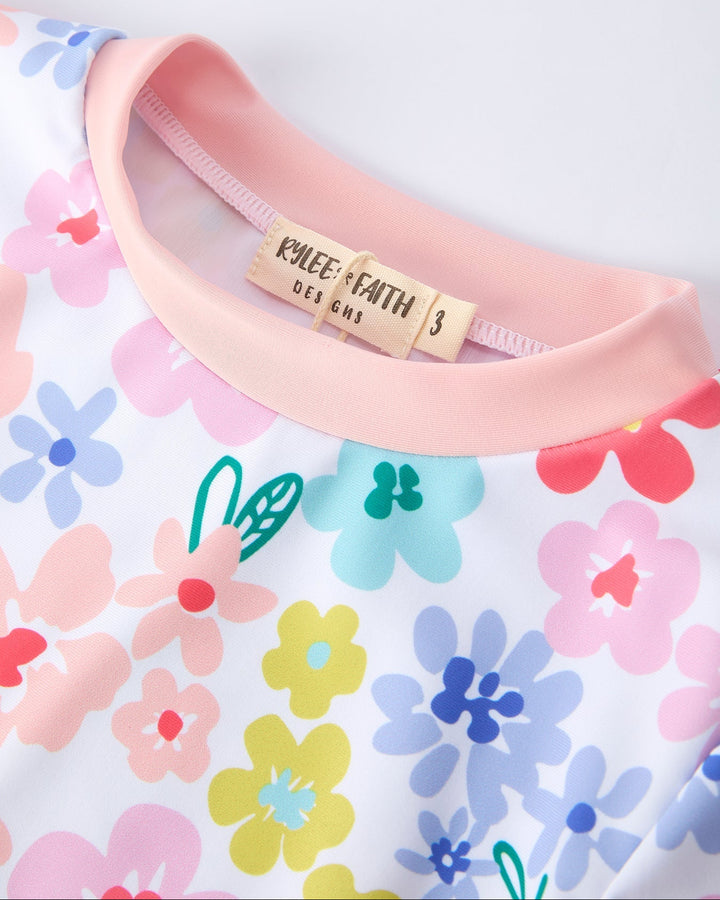 Floral-patterned fabric with a pink elastic band and visible brand label.