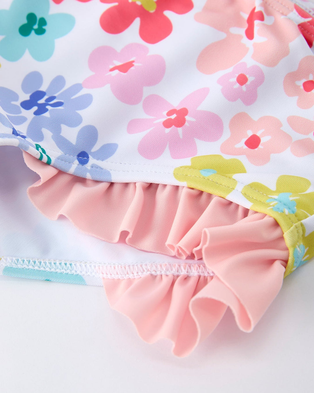 Floral-patterned fabric with ruffled edge on a white background